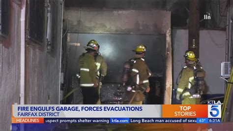 Garage fire in Fairfax District destroys vehicles, forces evacuations; may be connected to series of other arsons in the area 